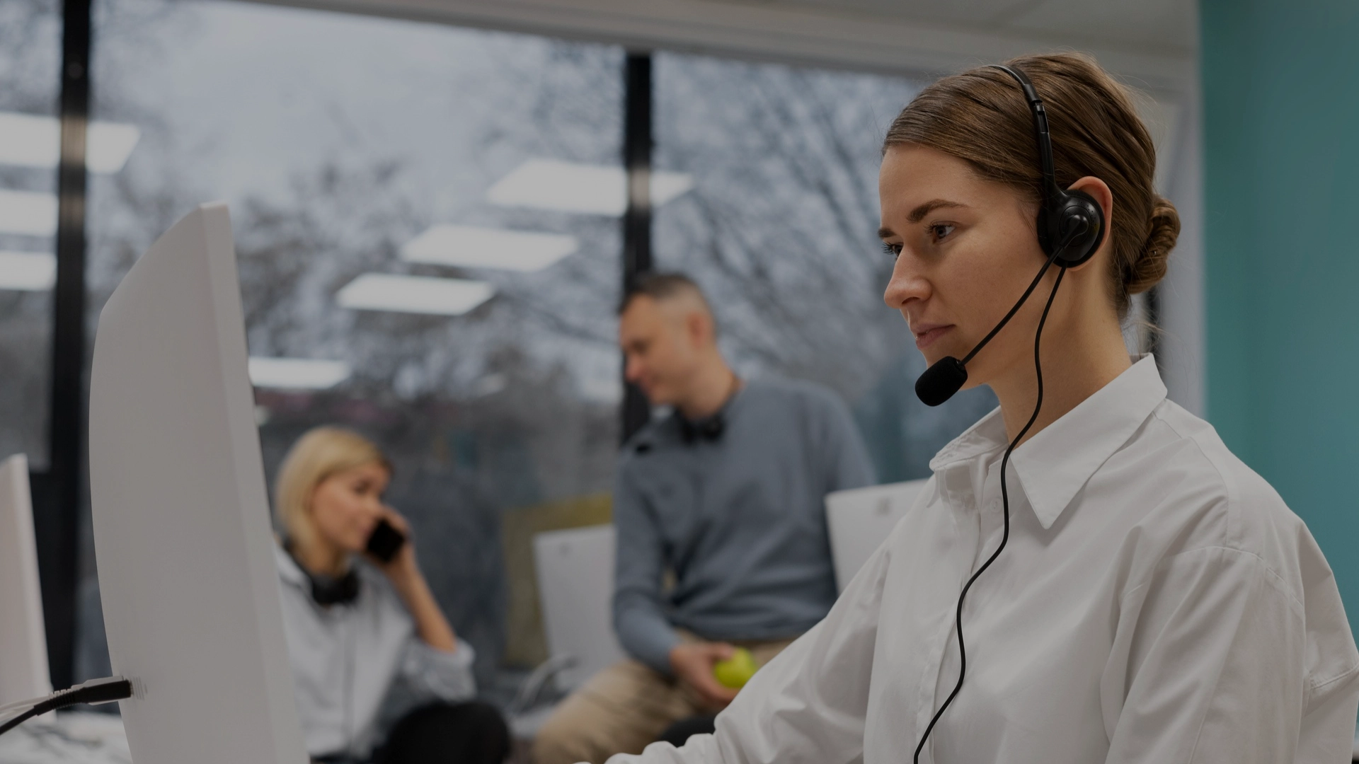 Customer service representative wearing a headset and assisting clients with heating and air conditioning inquiries.