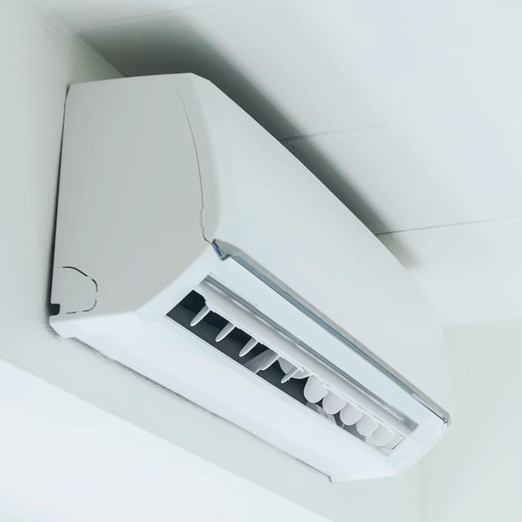 Close-up view of a sleek, white wall-mounted air conditioning unit with adjustable vents. This modern air conditioning system provides efficient cooling and heating solutions as part of high-quality HVAC services.